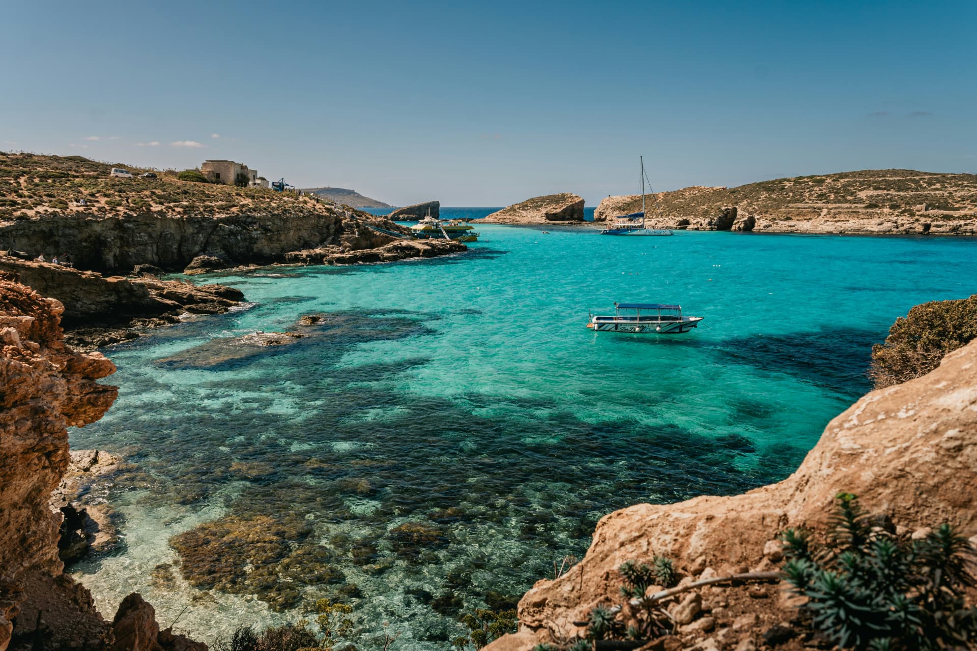 Turquoise lagoon with boats on the Maltese coast